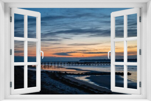 Fototapeta Naklejka Na Ścianę Okno 3D - Long pier at sea against a sunset sky