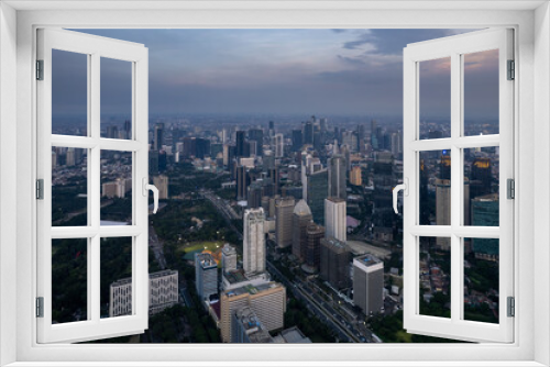 Fototapeta Naklejka Na Ścianę Okno 3D - aerial shoot of Jakarta skyline during the golden hour. Jakarta is the capital city of indonesia that also one of the most populated city in the world.