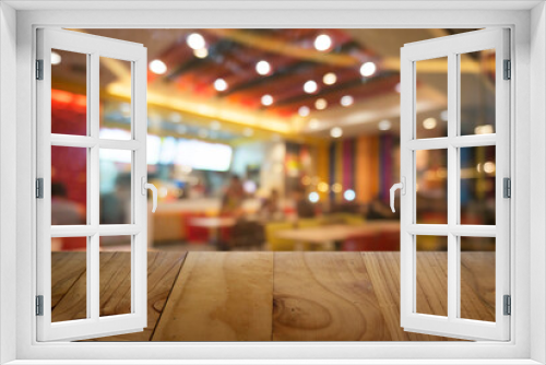 Empty wooden table in front of abstract blurred background of coffee shop . can be used for display Mock up  of product