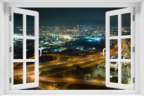 Fototapeta Naklejka Na Ścianę Okno 3D - Aerial view of american freeway intersection at night with fast driving cars and trucks in Tampa, Florida. View from above of USA transportation infrastructure