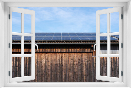 Fototapeta Naklejka Na Ścianę Okno 3D - photovoltaic cells on the roof of a wooden barn