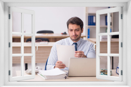 Young male employee working in the office