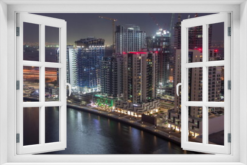 Fototapeta Naklejka Na Ścianę Okno 3D - Towers at the Business Bay aerial day to night timelapse in Dubai, United Arab Emirates
