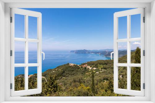 Fototapeta Naklejka Na Ścianę Okno 3D - A beautiful landscape of the coast of the island of Corfu in the Ionian Sea of the Mediterranean in Greece. Pure blue clear water washes over the shores of the Greek island.