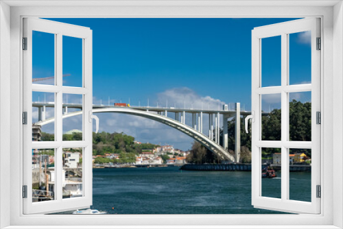 Fototapeta Naklejka Na Ścianę Okno 3D - Oporto, Portugal. April 13, 2022: Arrábida bridge and city landscape with blue sky.