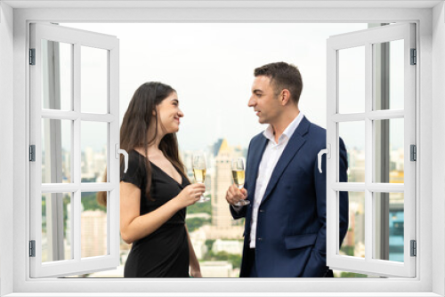 Happy couple with a glass of wine in bar indoors. Young man and woman on date in restaurant