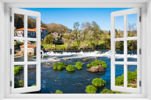 Fototapeta Naklejka Na Ścianę Okno 3D - A Ponte Maceira, Galicia, Spain - April 4, 2023: River Tambre running through the village