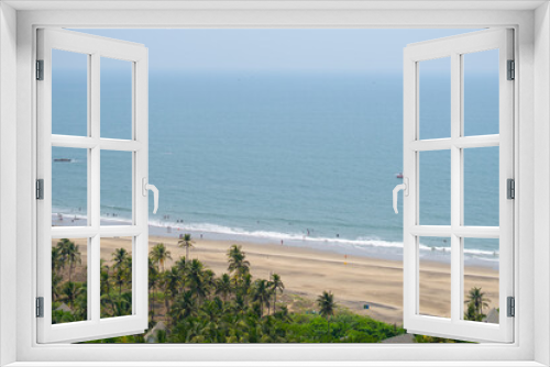 Fototapeta Naklejka Na Ścianę Okno 3D - Wide angle shot of Vagator beach as seen from the top of the Chapora Fort at Goa in India. Wide angle shot of beach as seen from above. Blue sea in goa. Summer relaxation background. 