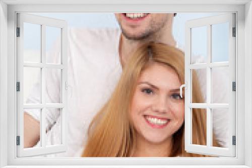 Young beautiful couple on a sofa at home