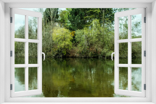 Fototapeta Naklejka Na Ścianę Okno 3D - Fishing Lake Surrounded By Trees Reflected In The Calm Water
