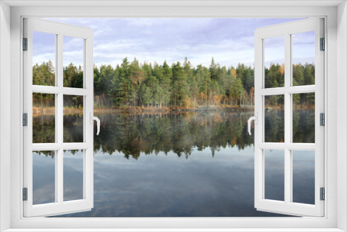 Fototapeta Naklejka Na Ścianę Okno 3D - Scenic view over forest lake