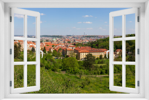 Fototapeta Naklejka Na Ścianę Okno 3D - Spring Prague City with St. Nicholas' Cathedral and colorful Nature with flowering Meadows from the Hill Petrin, Czech Republic