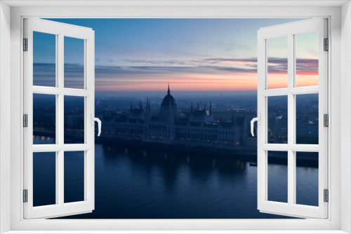 Fototapeta Naklejka Na Ścianę Okno 3D - Aerial view of Hungarian Parliament Building at sunrise with the Danube river, in Budapest, Hungary