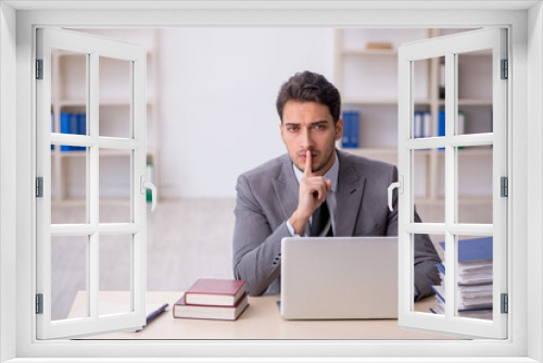 Young male employee working in the office