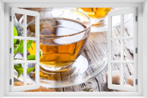 Fototapeta Naklejka Na Ścianę Okno 3D - Transparent cup of green tea on wooden background