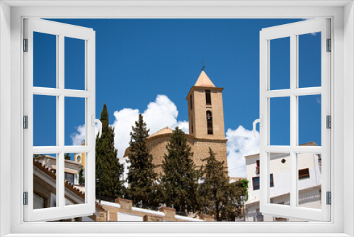 Fototapeta Naklejka Na Ścianę Okno 3D - Ancient Christian church in Córdoba, Spain. Catholic church. Religious church. Iznajar, Cordoba, Andalusia, Spain. Exterior view of the church building. 