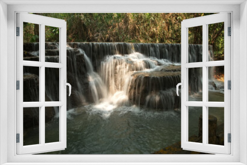 Fototapeta Naklejka Na Ścianę Okno 3D - Tat Kuang Si Waterfalls is a limestone waterfall emerald green Inside the waterfall, there is an orderly tour arrangement. It is known as the most beautiful waterfall of Luang Prabang city in Laos.
