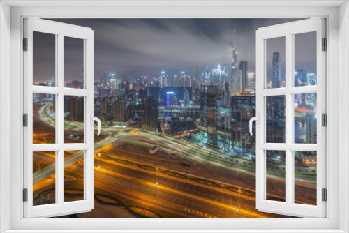 Fototapeta Naklejka Na Ścianę Okno 3D - Panoramic skyline of Dubai with business bay and downtown district all night timelapse.