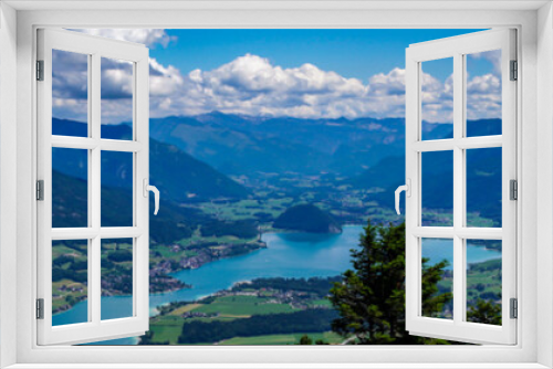 Fototapeta Naklejka Na Ścianę Okno 3D - View of Wolfgangsee lake and surrounding Alps mountains from Zwolferhorn mountain in Salzkammergut region, Austria. Spectacular view from a mountain peak on a clear sunny day with blue sky.