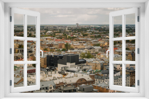 Fototapeta Naklejka Na Ścianę Okno 3D - Aerial view of a residential district in an ancient city, filled with bustling crowds and awe-inspiring architecture of Riga