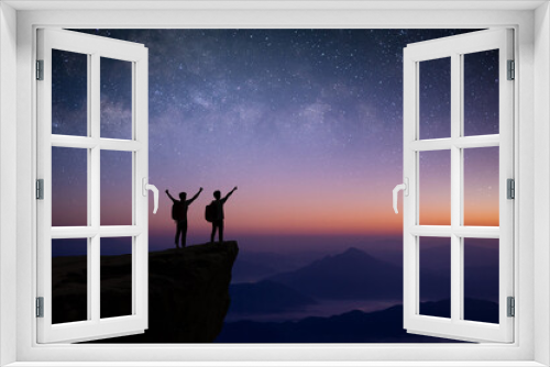 Fototapeta Naklejka Na Ścianę Okno 3D - Silhouette of couple young traveler and backpacker watched the star and milky way alone on top of the mountain. He enjoyed traveling and was successful when he reached the summit.