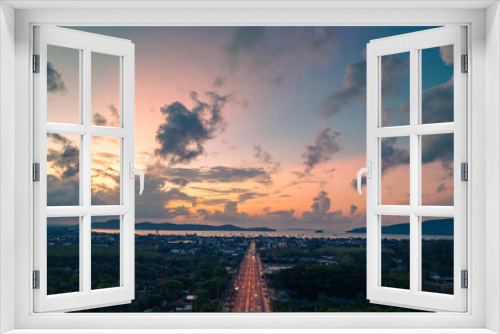 Fototapeta Naklejka Na Ścianę Okno 3D - aerial view colorful sky at sunrise above the main road..aerial view scenery light through to sky above Chalong gulf..amazing sky of bright sunrise in nature and travel concept