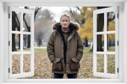 Full-length portrait photography of a tender mature man wearing a warm parka against a vibrant city park background. With generative AI technology