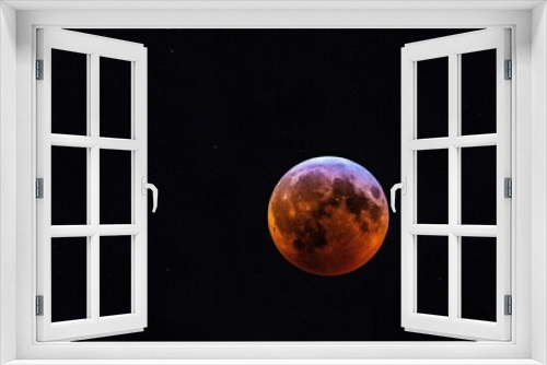 Fototapeta Naklejka Na Ścianę Okno 3D - the blood moon is seen during a lunar eclipse in this photograph