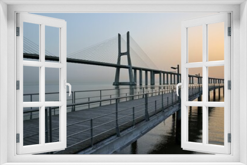 Fototapeta Naklejka Na Ścianę Okno 3D - Mesmerizing sunrise view over the Vasco of Gama Bridge on the Tagus River in Lisbon, Portugal