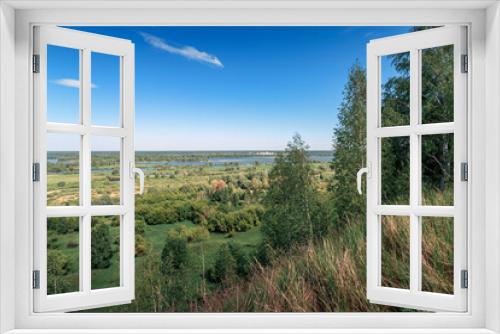 Fototapeta Naklejka Na Ścianę Okno 3D - View from the hill to the green meadows. Summer landscape.