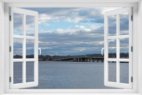 Fototapeta Naklejka Na Ścianę Okno 3D - View across the waters of the Navesink River at the Oceanic Bridge and the town of Rumson, New Jersey, on a cloudy day -01