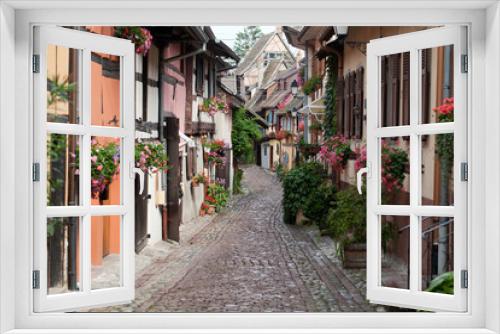 Fototapeta Naklejka Na Ścianę Okno 3D - Street with half-timbered medieval houses in Eguisheim
