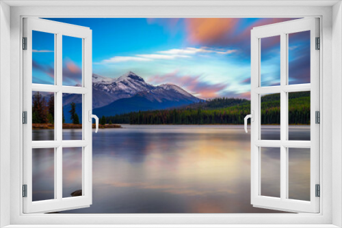 Fototapeta Naklejka Na Ścianę Okno 3D - Sunset over Maligne Lake in Jasper National Park, Canada, with snow-covered peaks of canadian Rocky Mountains in the background. Long exposure.