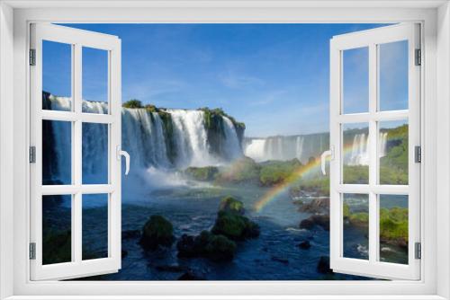 Fototapeta Naklejka Na Ścianę Okno 3D - Iguazu Falls on the border between Argentina and Brazil with beautiful rainbows and lots of vegetation and lots of water falling down them