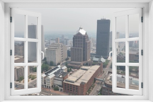 Fototapeta Naklejka Na Ścianę Okno 3D - Downtown Rochester NY in dense smoke from Canadian wildfires blowing over city skyline caused by climate change