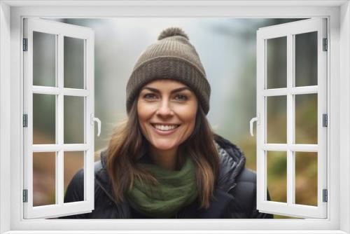 Medium shot portrait photography of a satisfied mature girl wearing a warm beanie or knit hat against a foggy forest background. With generative AI technology