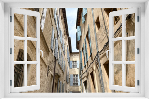 Fototapeta Naklejka Na Ścianę Okno 3D - Arles, France - 26.04.2023. Street view of Arles, in the south of France. Facade of old residential building with shutters on windows. Charming narrow street view of Arles, Provence south of France.