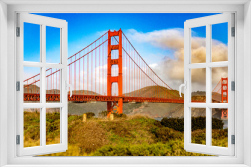 Fototapeta Naklejka Na Ścianę Okno 3D - Golden Gate Bridge in the city of San Francisco, in the state of California in the USA, under a blue sky and beautiful clouds. Concept America.