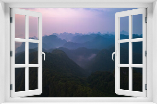 Fototapeta Naklejka Na Ścianę Okno 3D - Aerial top view of forest trees and green mountain hills with fog, mist and clouds. Nature landscape background, Vietnam.