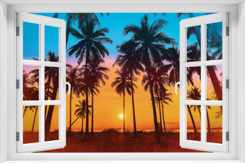 Fototapeta Naklejka Na Ścianę Okno 3D - Silhouette coconut palm trees on beach at sunset. Vintage tone.