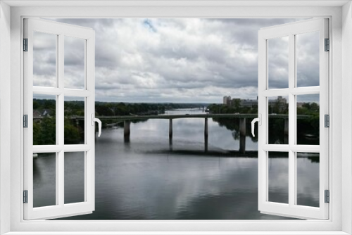 Fototapeta Naklejka Na Ścianę Okno 3D - Drone view of a bridge connecting the riverbanks on a cloudy day