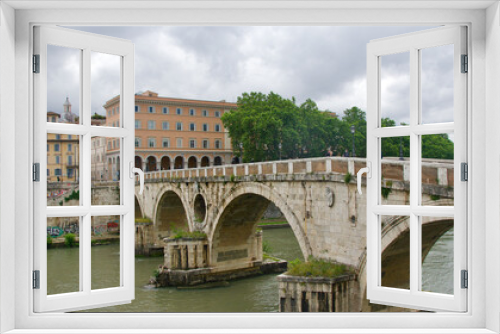 Ancient Ponte Sisto bridge standing over Tiber River in Rome, Italy