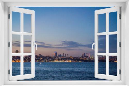 Istanbul at sunset, Turkey. Tourist boat sails on Golden Horn in summer. Beautiful sunny view of Istanbul waterfront with old mosque. Concept of travel, tourism and vacation in Istanbul and Turkey