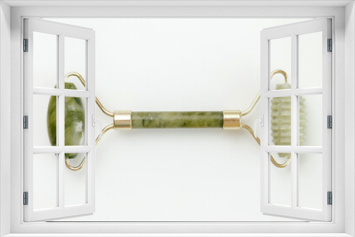 Fototapeta Naklejka Na Ścianę Okno 3D - Facial jade massage roller made of green quartz stone on white background.