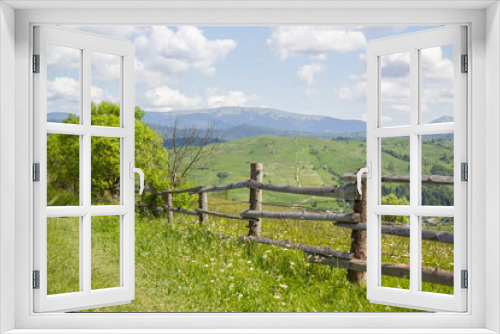 Fototapeta Naklejka Na Ścianę Okno 3D - wooden fence in the mountains of the Carpathians against the backdrop of a green meadow