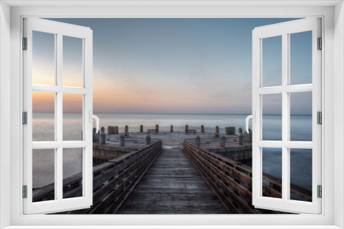 Fototapeta Naklejka Na Ścianę Okno 3D - Morning on the pier and the roundabout overlooking the sea with the splendid colors of sunrise