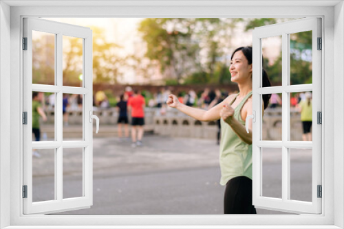 Female jogger. Fit young Asian woman with green sportswear aerobics dance exercise in park and enjoying a healthy outdoor. Fitness runner girl in public park. Wellness being concept