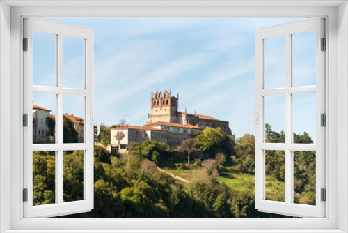 Fototapeta Naklejka Na Ścianę Okno 3D - Panoramic view of the medieval castle of San Vicente de la barquera. On the top of a hill surrounded by vegetation and next to the sea during a sunny summer day in cantabria.