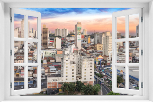 Fototapeta Naklejka Na Ścianę Okno 3D - Campinas, Sao Paulo, Brazil. June 23, 2023. Aerial image of three central districts of Campinas: Vila Itapura, Cambuí and Jardim Guanabara. Sunset and blue sky.