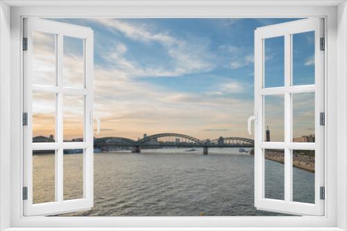 Fototapeta Naklejka Na Ścianę Okno 3D - Panoramic view of the Rhine river at sunset as it passes through the city of Cologne in Germany.